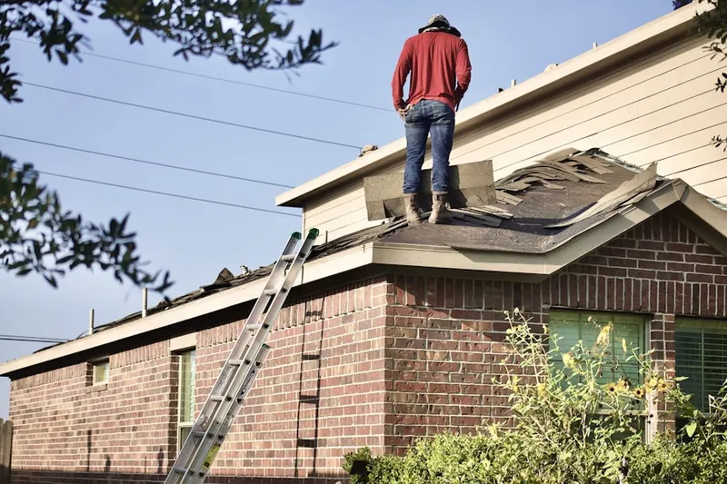 Professional roofer working on a residential roof in Bellbrook